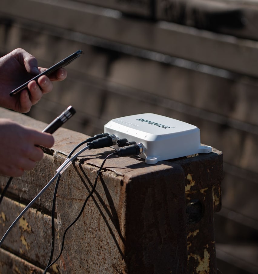 Reporter lying on a brick wall