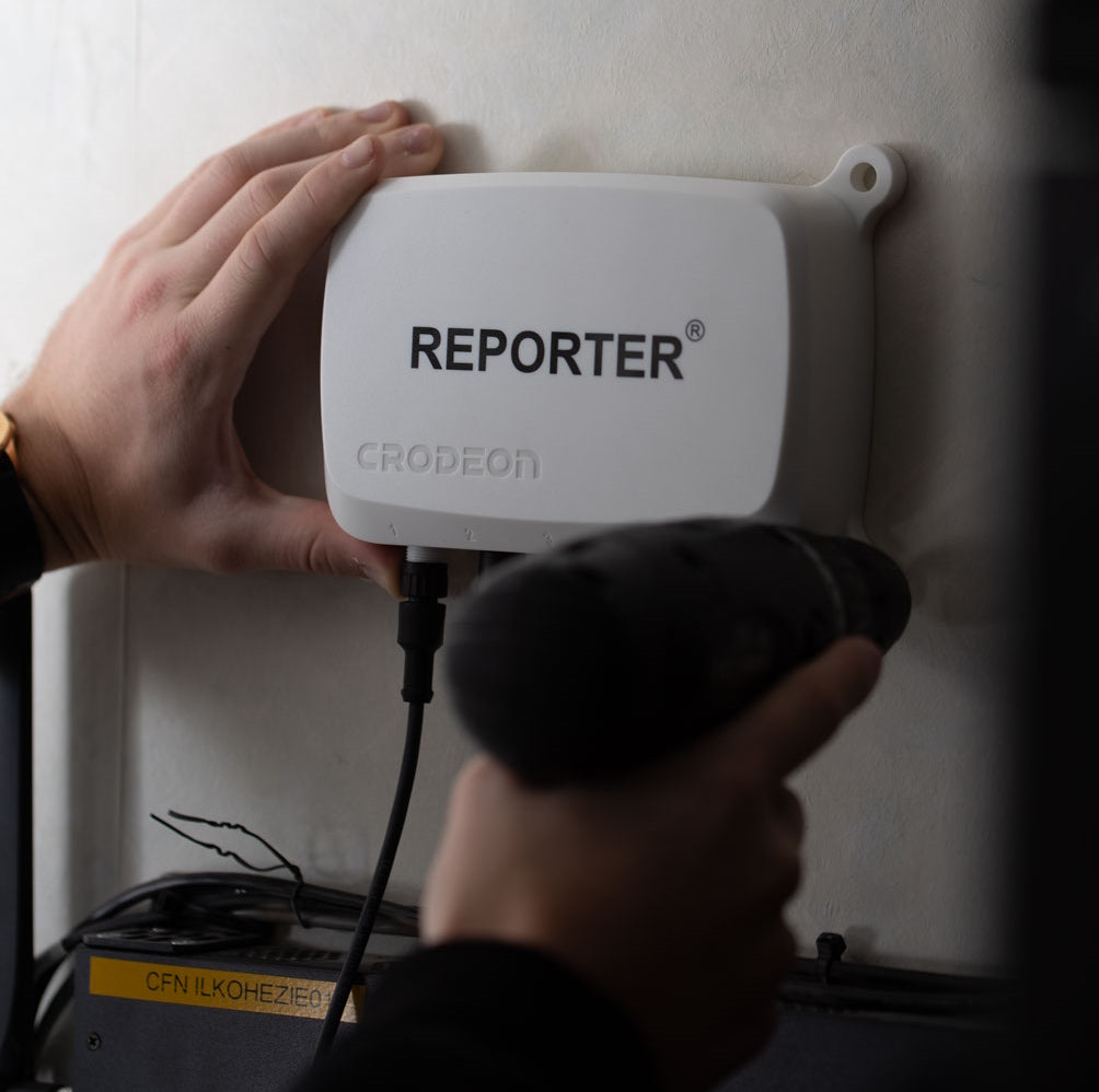 Reporter being installed on an indoor wall