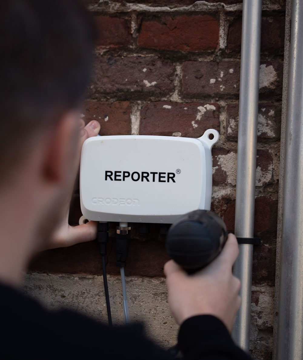 Reporter on a brick wall