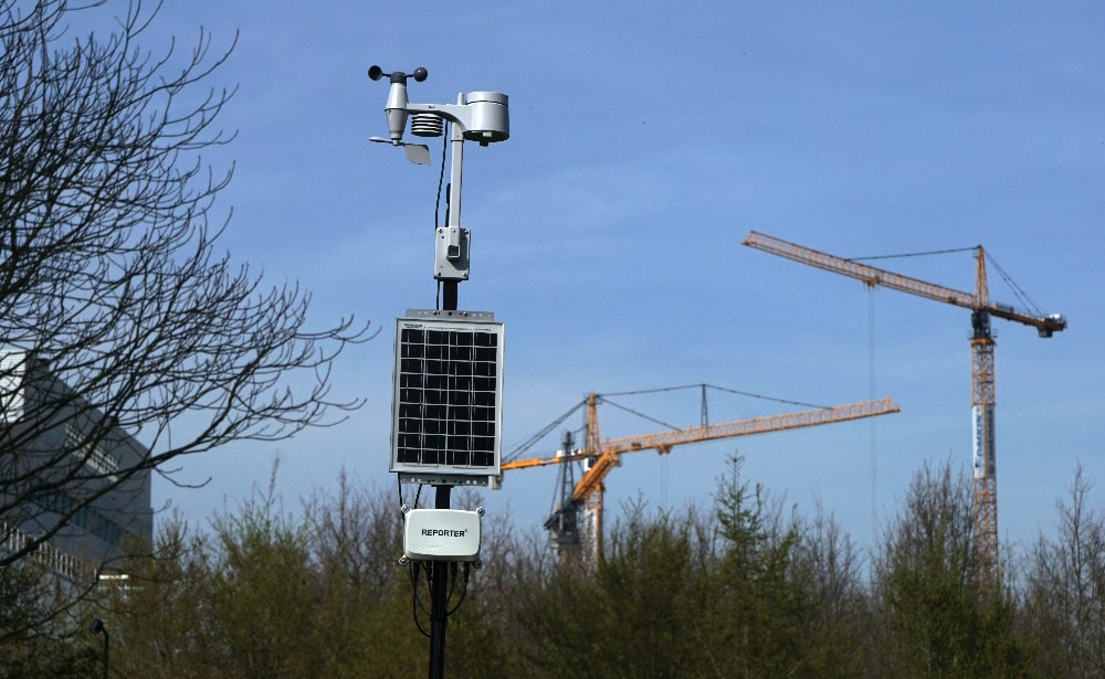 The Crodeon weather station next to cranes on a construction site